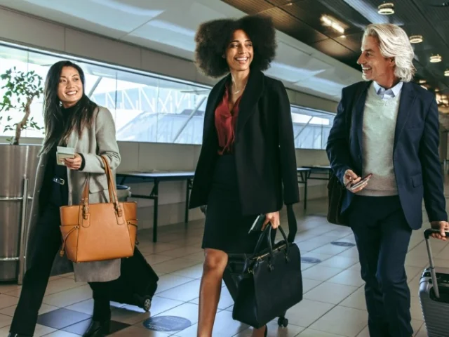 International business travelers using business credit card walking through the airport