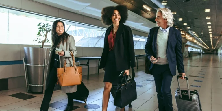 International business travelers using business credit card walking through the airport