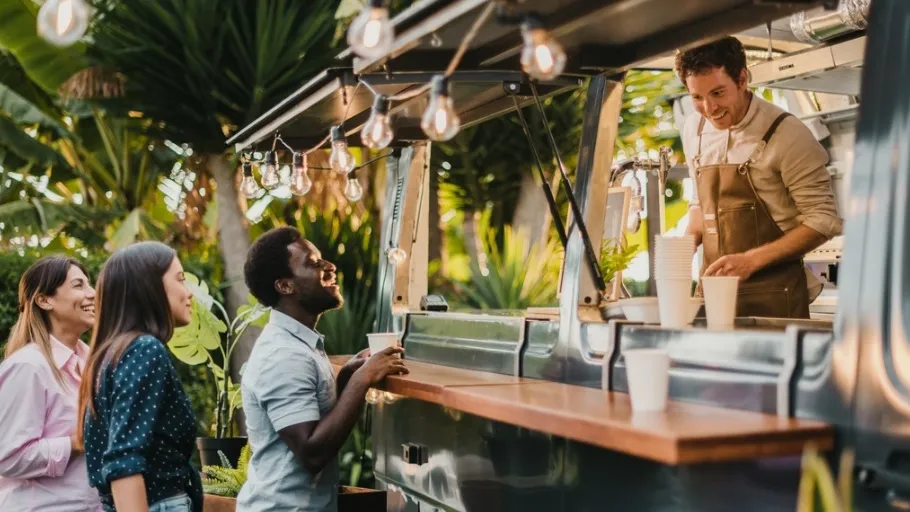Food truck owner serving three customers