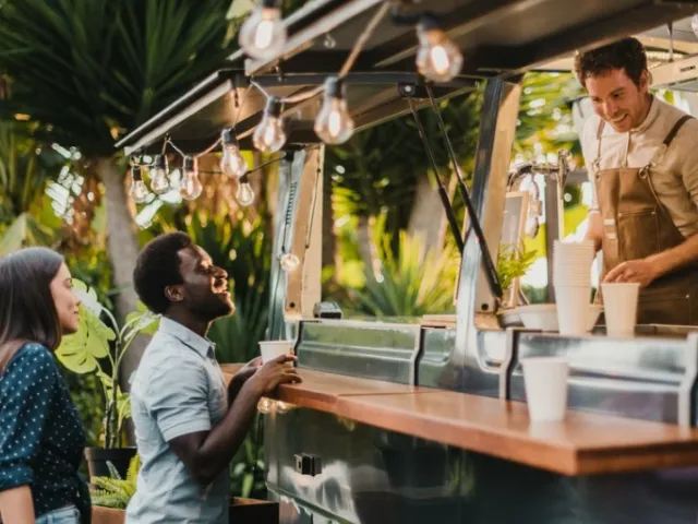 Food truck owner serving three customers