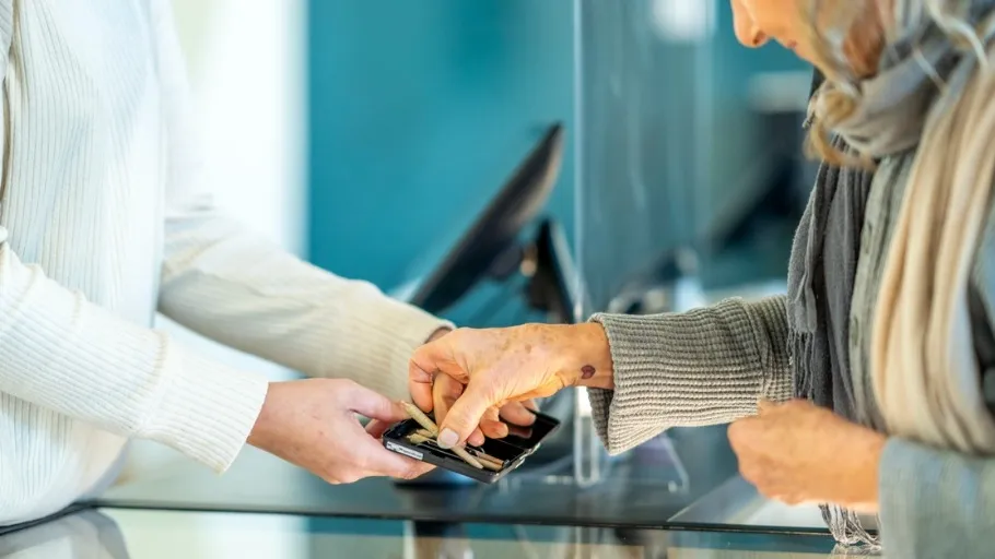 A retail clerk helping a woman at a cannabis shop
