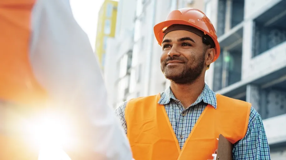Construction engineer shaking hands with materials financing expert