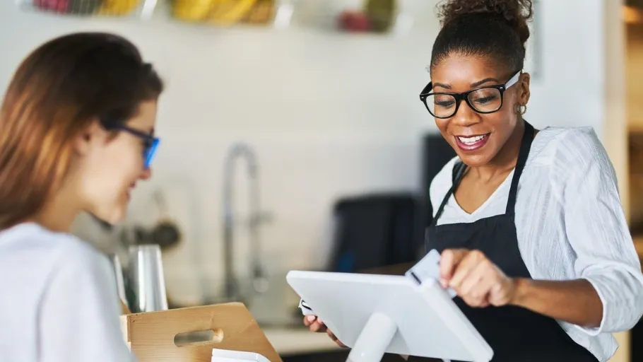 Woman Small business owner swiping a customer's credit card