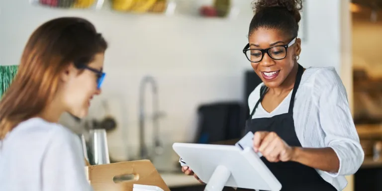 Woman Small business owner swiping a customer's credit card