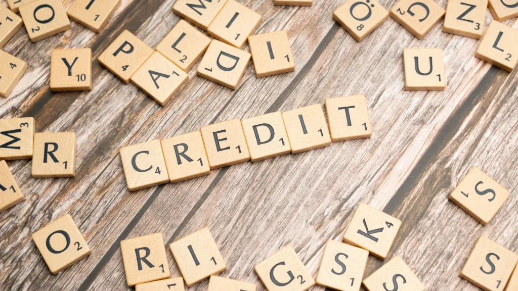 scrabble tiles that spell out the word credit