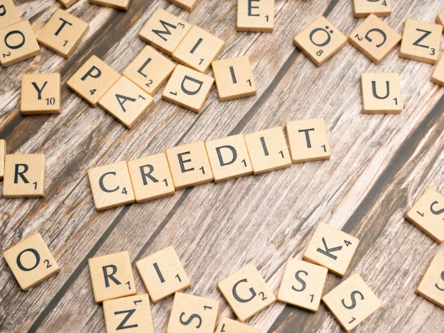 scrabble tiles that spell out the word credit