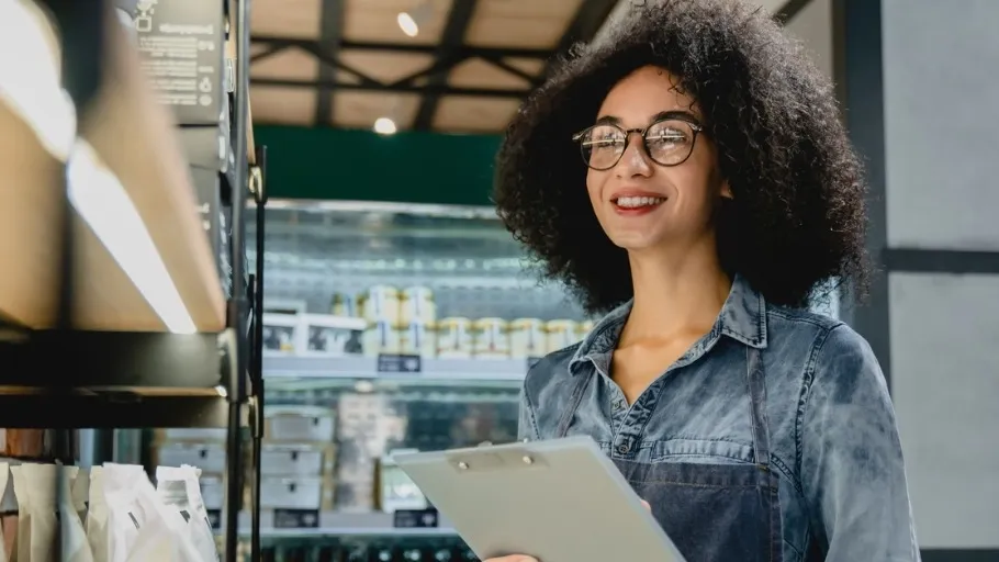 Young grocery store business owner checks inventory