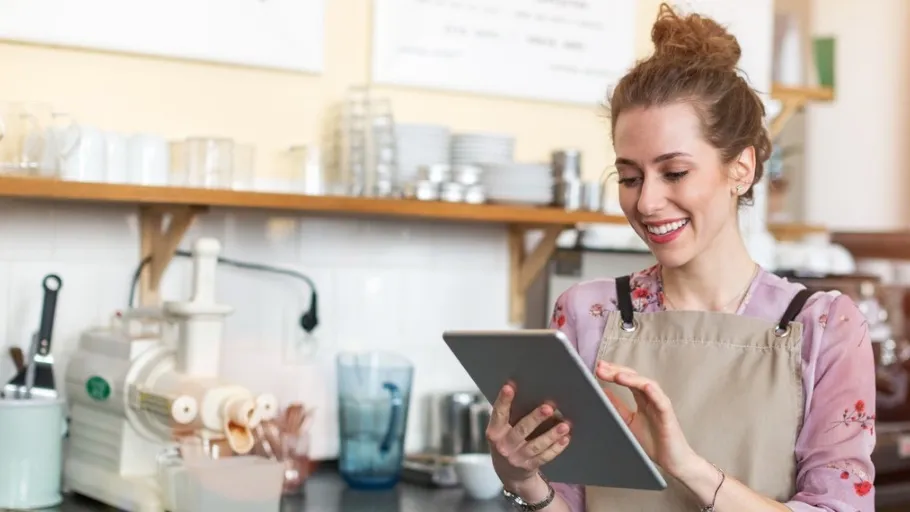 A female small business owner researching small business loan forgiveness on an ipad
