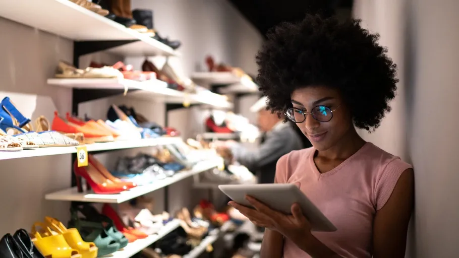 Women using a tablet to check inventory at a shoe store