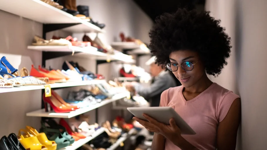 Women using a tablet to check inventory at a shoe store