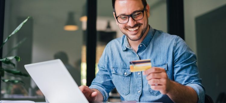 Self employed man looks at credit card