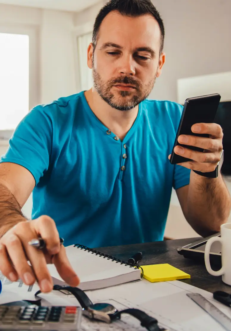 Business owner on phone working at desk